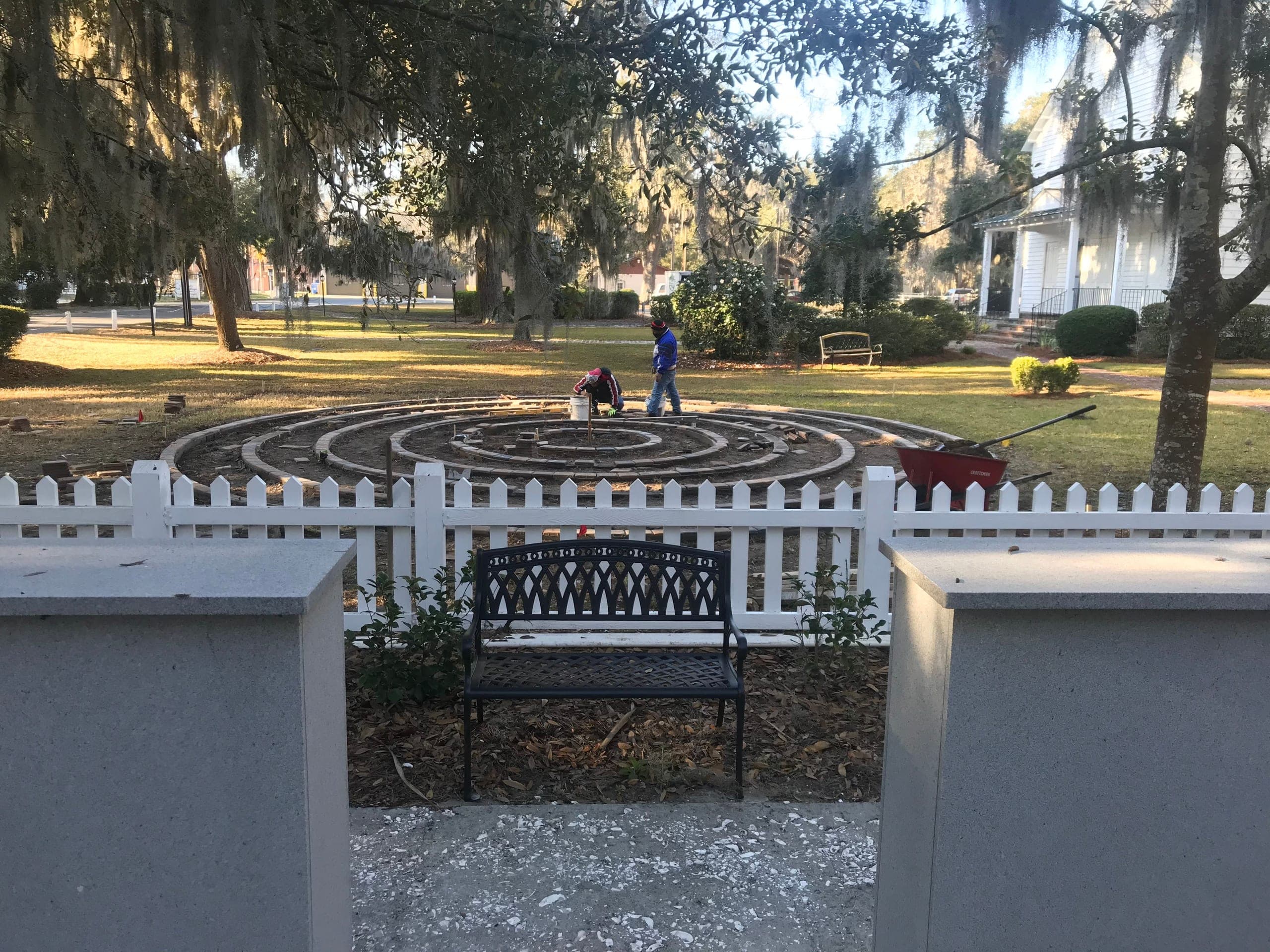 The crew lays the brick labyrinth at Isle of Hope, course by course.
