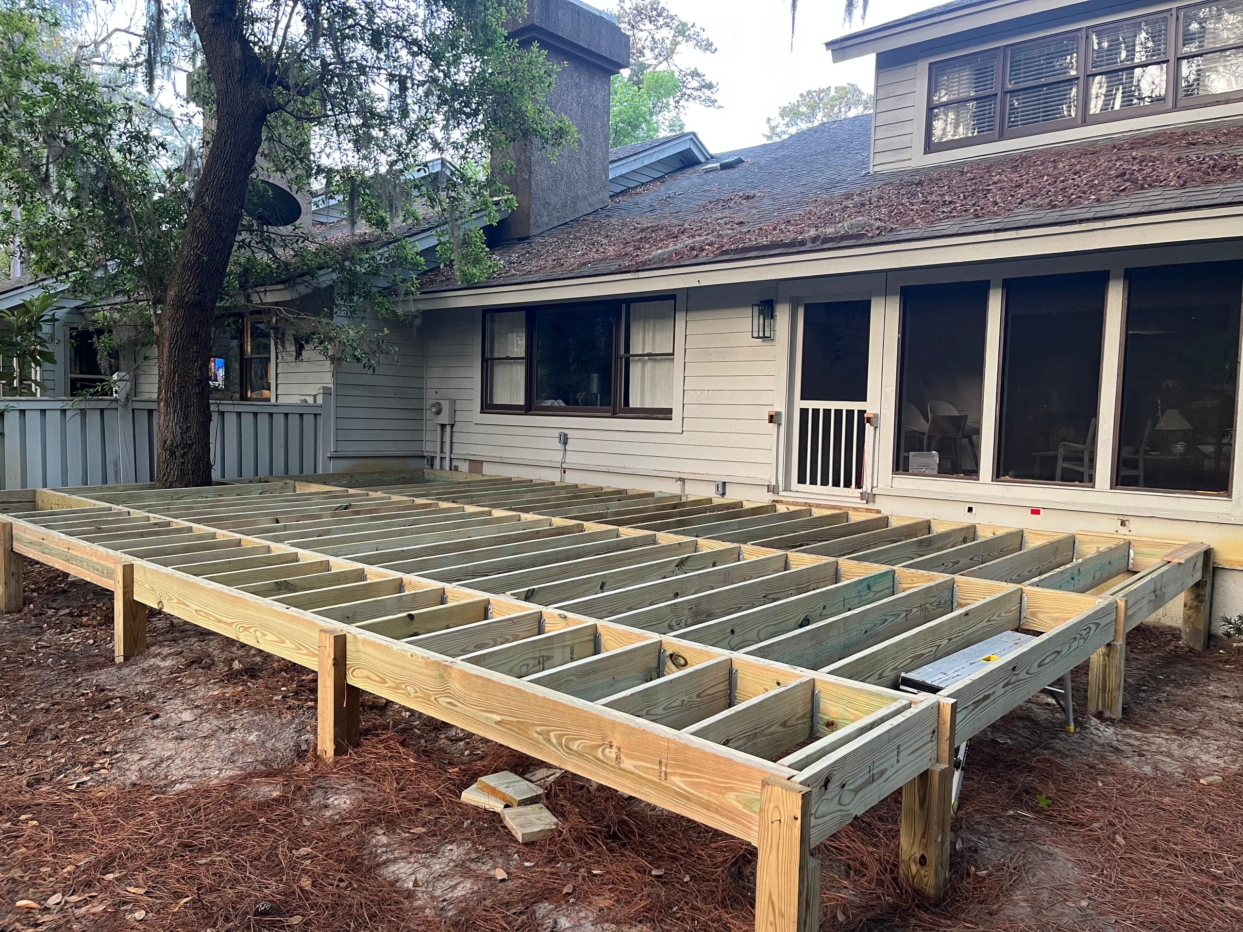 Completed joist framing for the raised deck before decking.